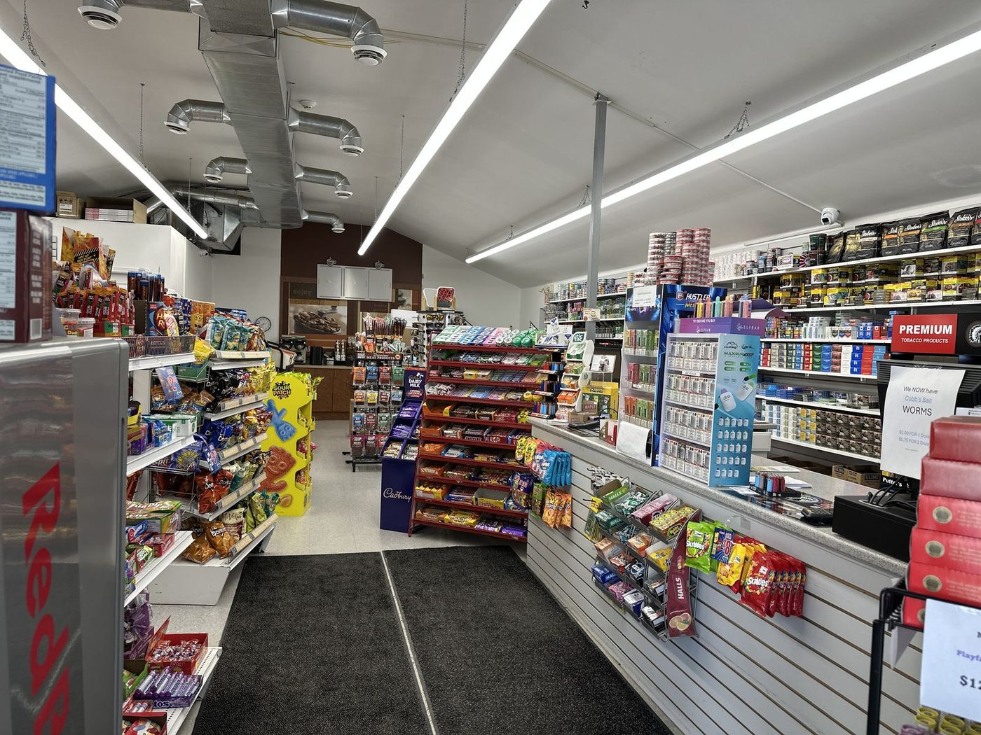 Convenience store shelves stocked with snacks and drinks